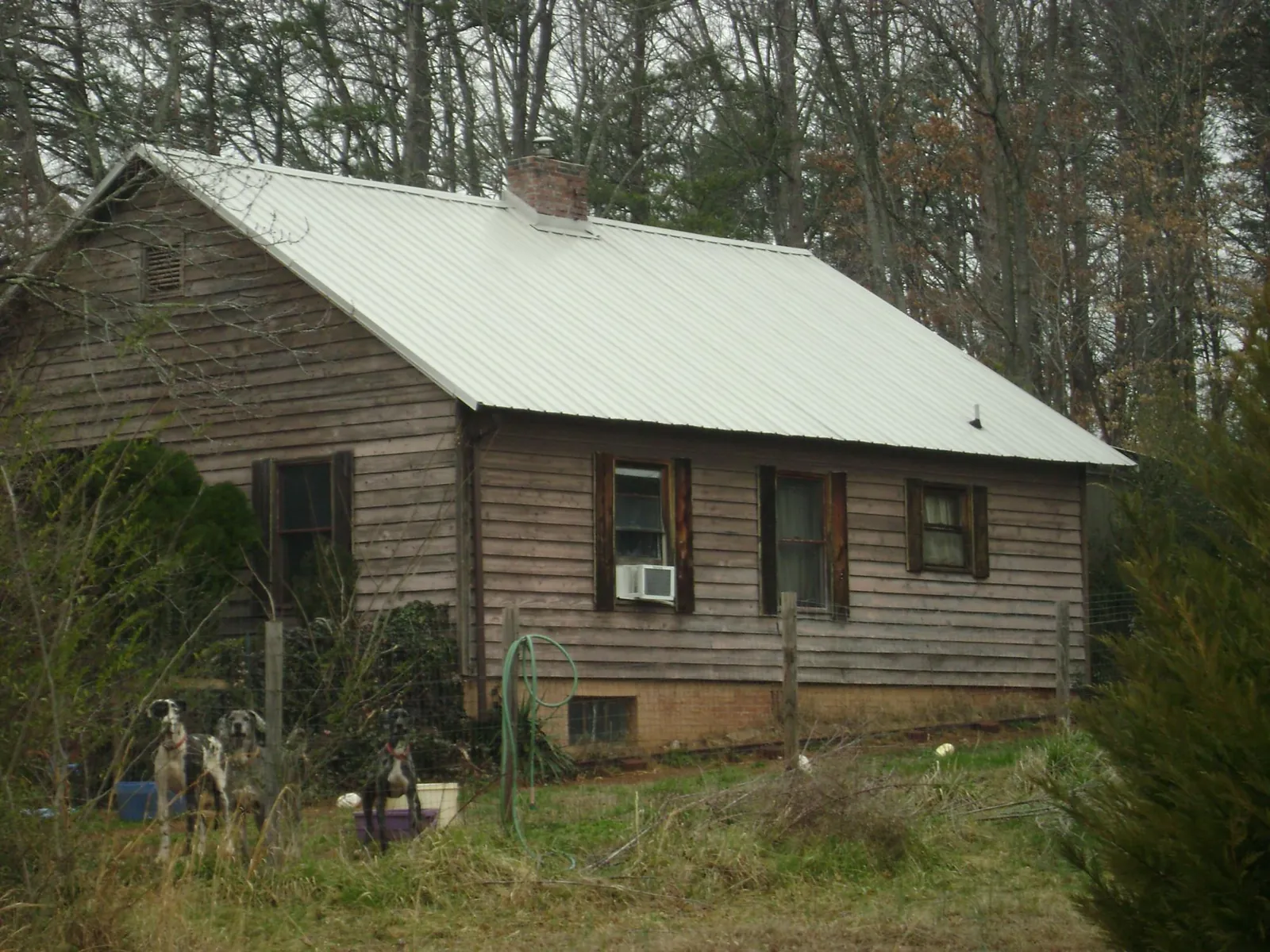 White metal roof on an old wood sided farmhouse, from a Metal Roof Installation job in Millers Falls